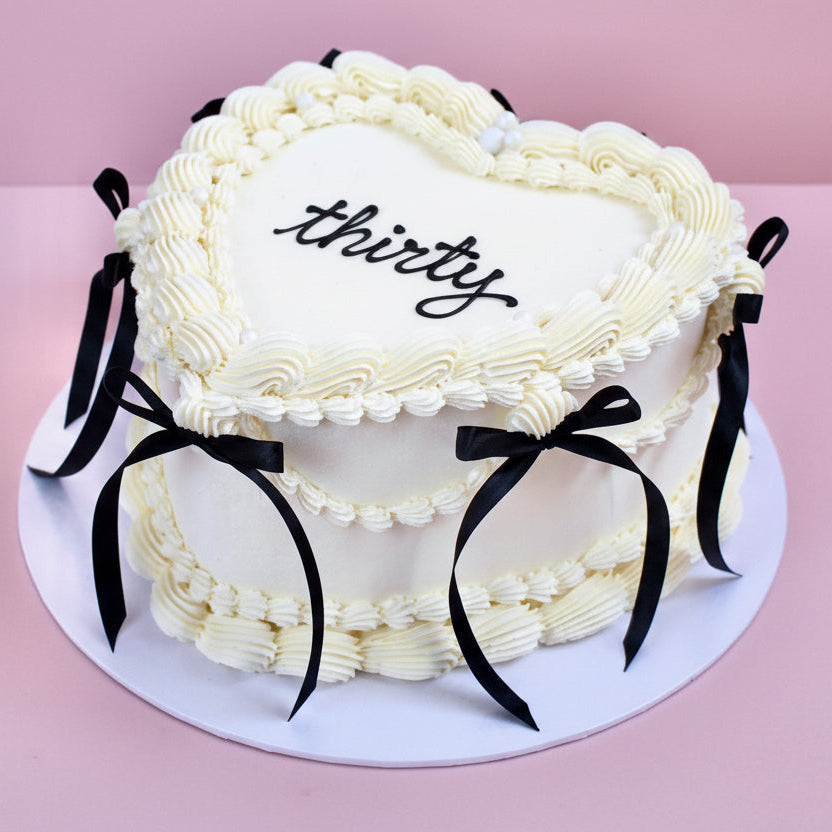 White and black vintage heart cake with ribbons