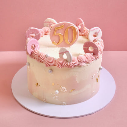 Pink vintage buttercream cake with party rings