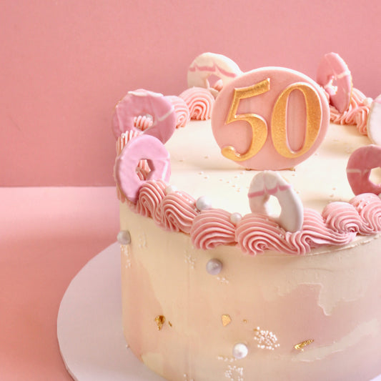 Pink vintage buttercream cake with party rings