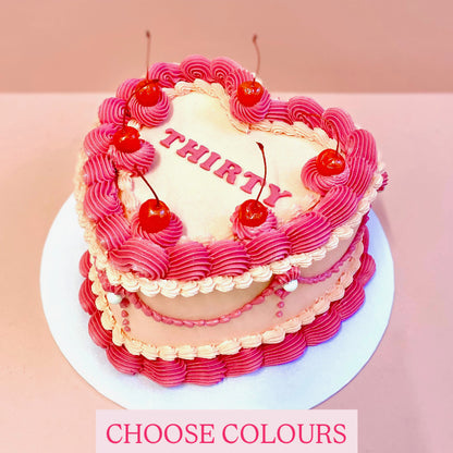 Pink vintage heart cake with cherries
