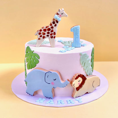 Safari buttercream children's cake with giraffe, lion and elephant edible handcrafted decorations.