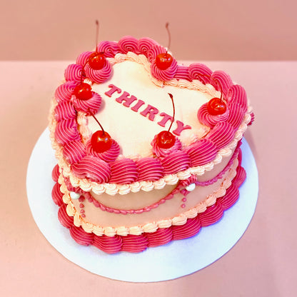 Vintage heart buttercream cake with cherries decoration