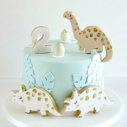 Dinosaur children's birthday cake in a buttercream cake with hand painted edible dinosaurs decorations 